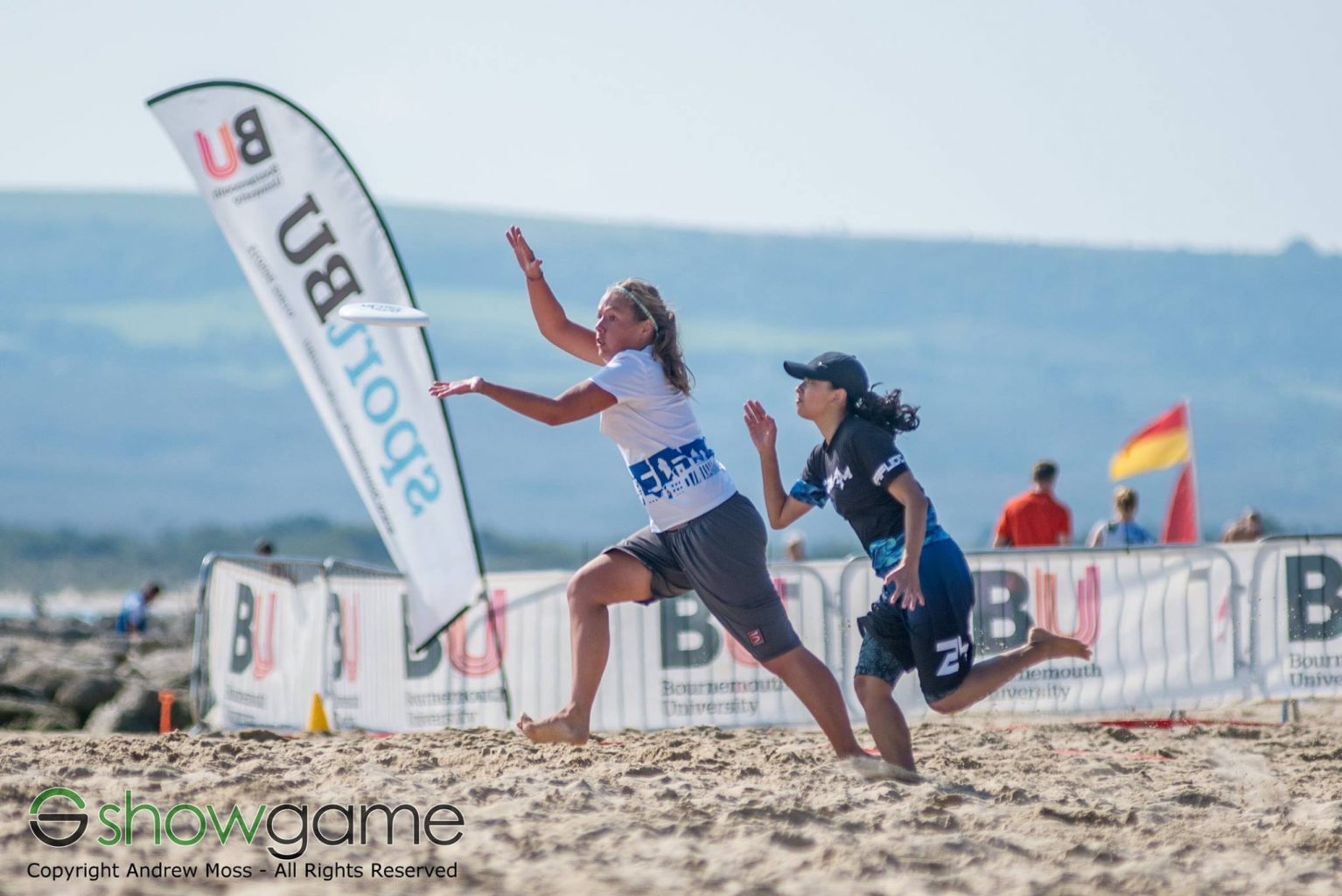 Two women plating frisby on Bournemouth beach Frisby tournament on the beach