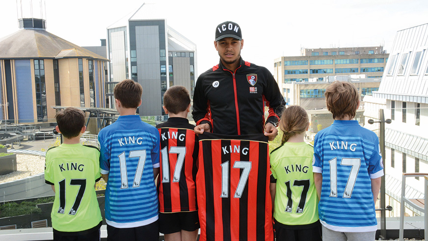 Former Cherries star Josh King with local children on our Talbot Campus