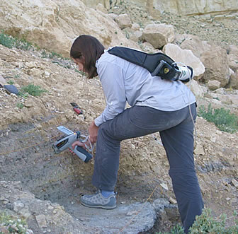 Portable x-ray fluorescence being used in situ, with helium purge adapter, on midden layers at 20th century abandoned village Al Ma’tan, Jordan