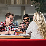 Three students sitting at a desk