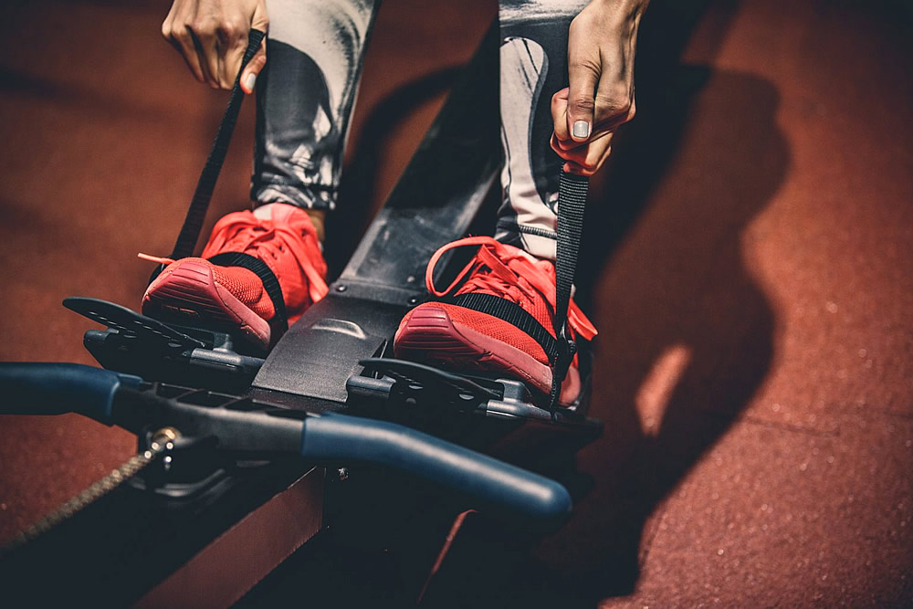 Sports trainers on a rowing machine