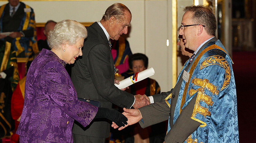 The late Queen Elizabeth II meeting Professor John Vinney at the Queen’s Anniversary Prize event in 2011