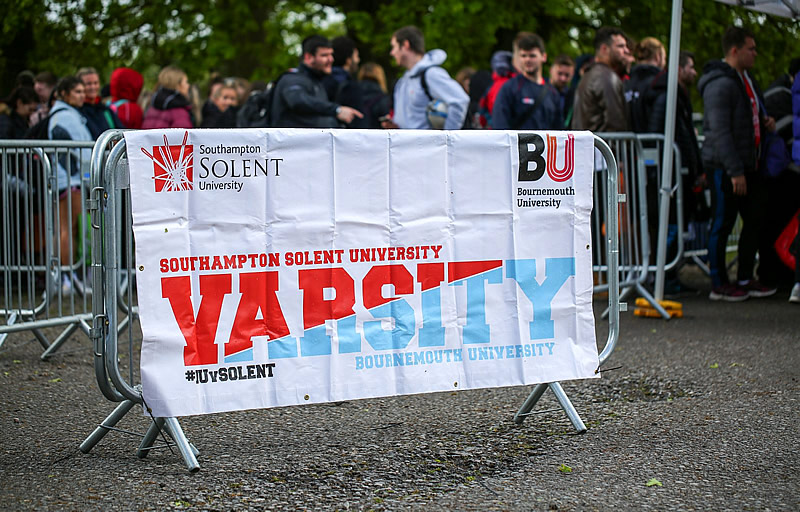 Image of a Varsity banner on a barrier Varsity banner