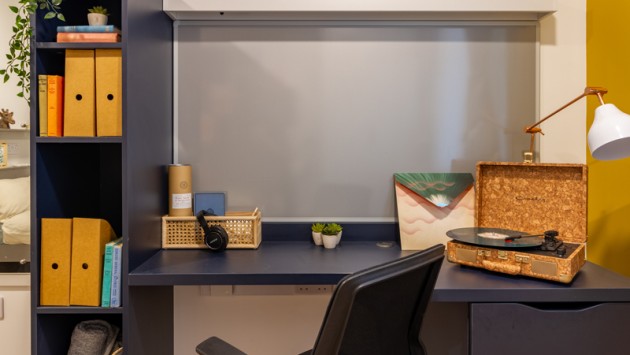 A desk area in a bedroom in Belaton House, featuring study and book space