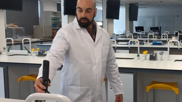 A Learning Technologist holding a 360-degree camera