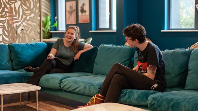 Belaton House communal area, featuring two students sitting on a sofa