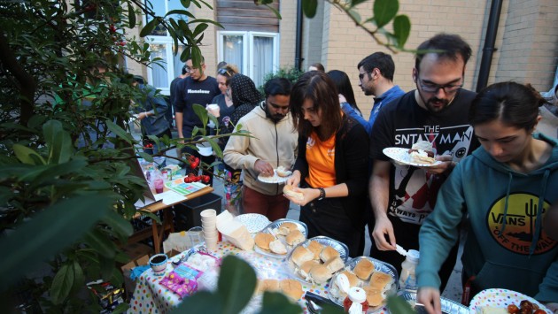 Students at an indoor BBQ event at Okeford House