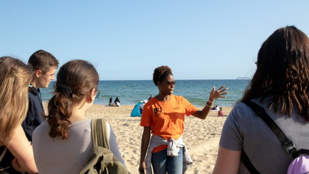 Image of students being given a tour of Bournemouth Beach