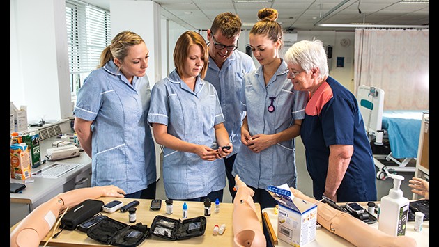 Nursing students in a practical learning session on the ward