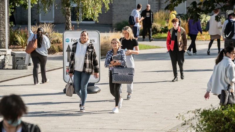 Students walking through Talbot Campus courtyard on a sunny day