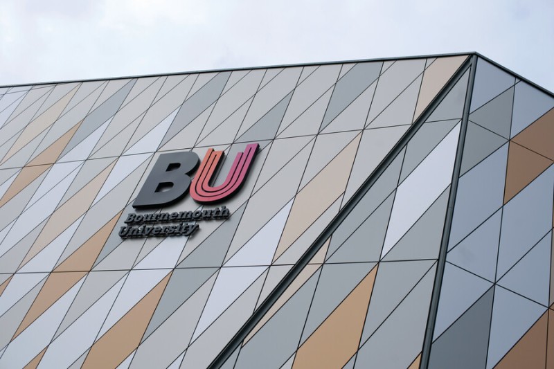 The BU logo on the top of Poole Gateway Building 