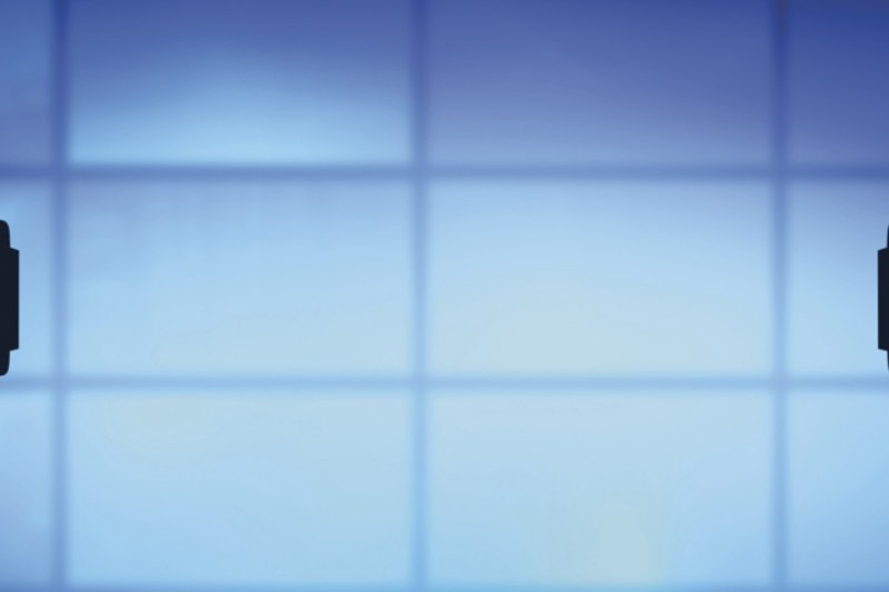 Two television cameras pointing at a blue screen