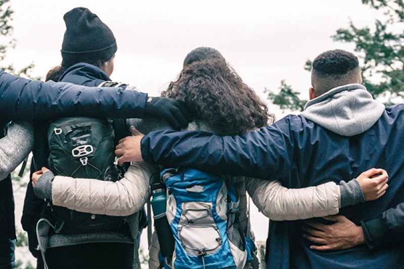 Group of young people with arms around