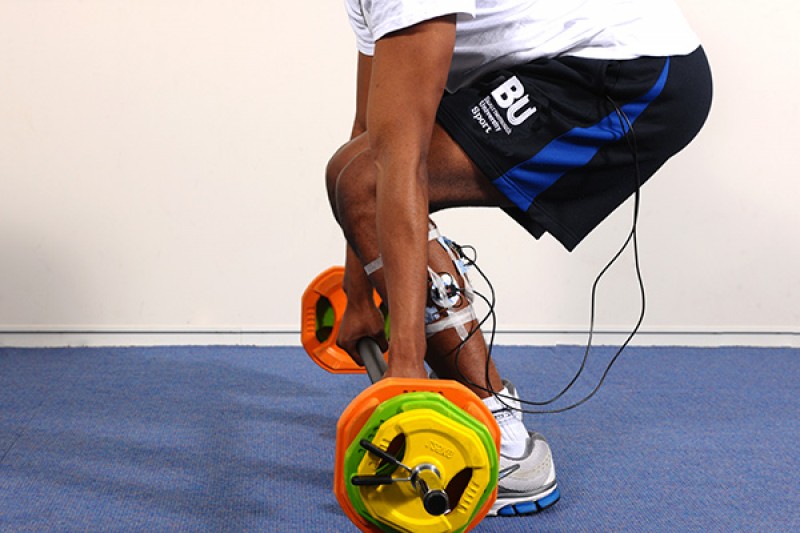 Image of a man lifting bar and weights