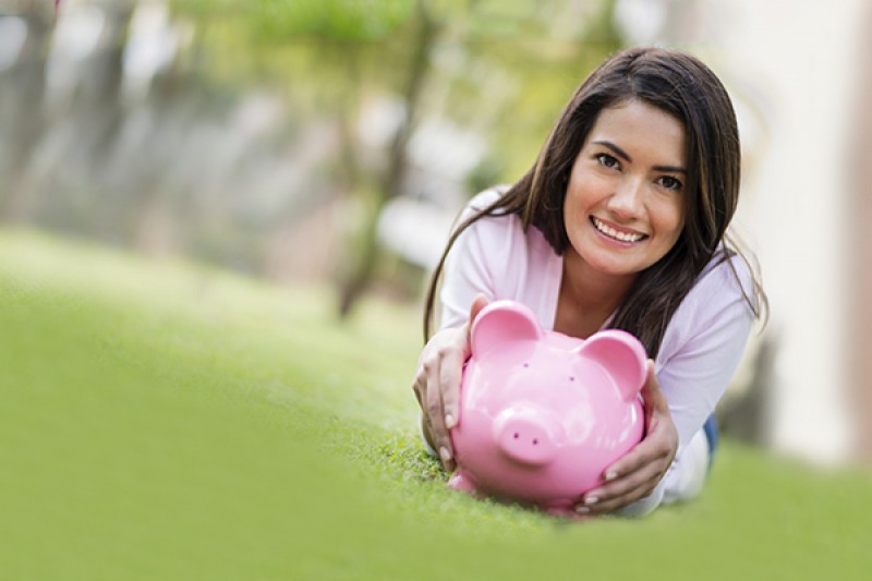 girl holding a piggy bank