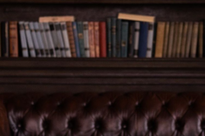 A bookcase with a bronze statue of Lady Justice in front of it