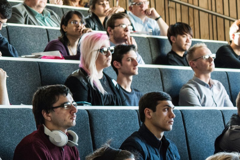 An audience in a lecture studio listening to a talk