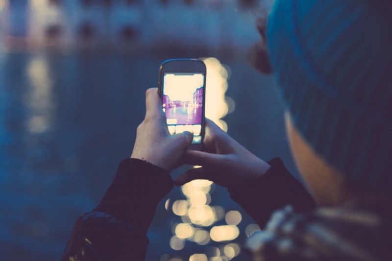 Young person taking photo on a mobile phone