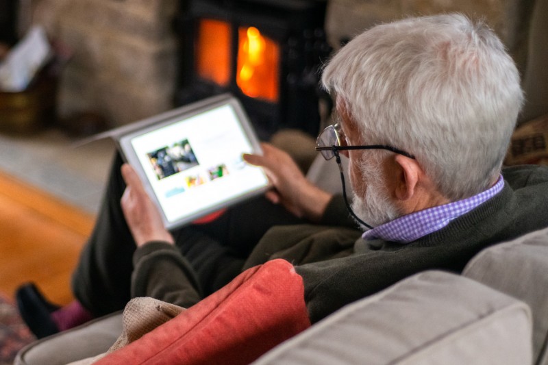 older man on tablet 