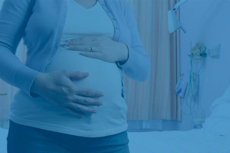 An image of a pregnant woman with her hands on her bump