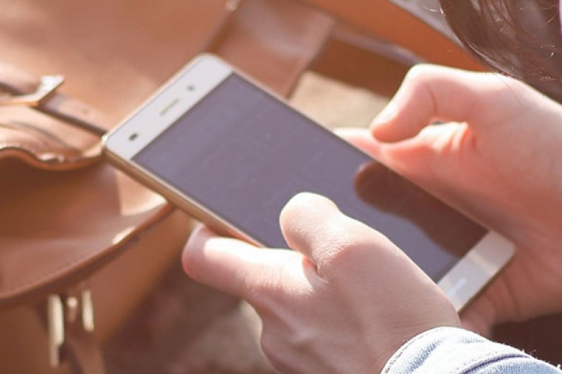 Hands holding a mobile phone