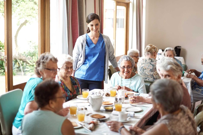Care home residents sat around a dining table