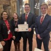 students standing with award