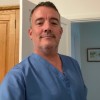 Student James Savage takes a selfie from home in his nursing scrubs