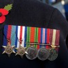 Military medals with a poppy on a veteran's chest