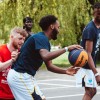 A group of male students playing Basketball