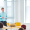 A man teaching a room of adults learners