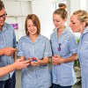 Nursing students in a practical session with an academic