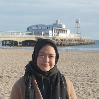 Tika Nur, a BU student from Indonesia, on Bournemouth beach with the pier in the background