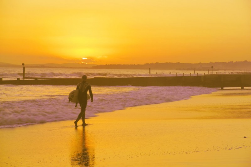 A surfer on Bournemouth beach