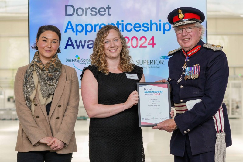 Abigail holding a certificate at the awards ceremony