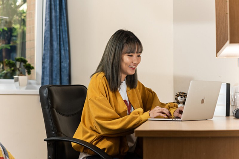 Student in accommodation sitting at desk
