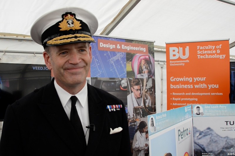 Rear Admiral Anthony Rimington, Director for Strategy and Policy at the Royal Navy standing in front of the BU stand