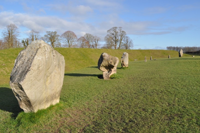 Some large stones on an open green plain