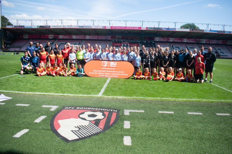 The teams posing for a group photo