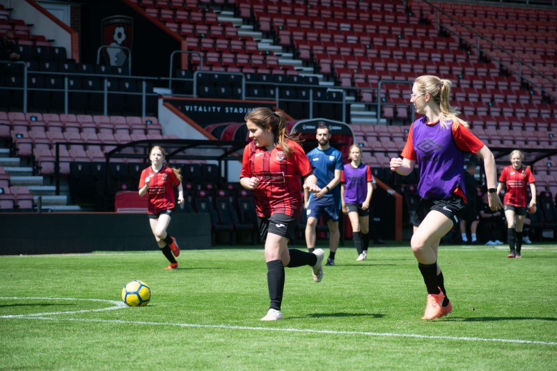 Footballers in action, running with the ball