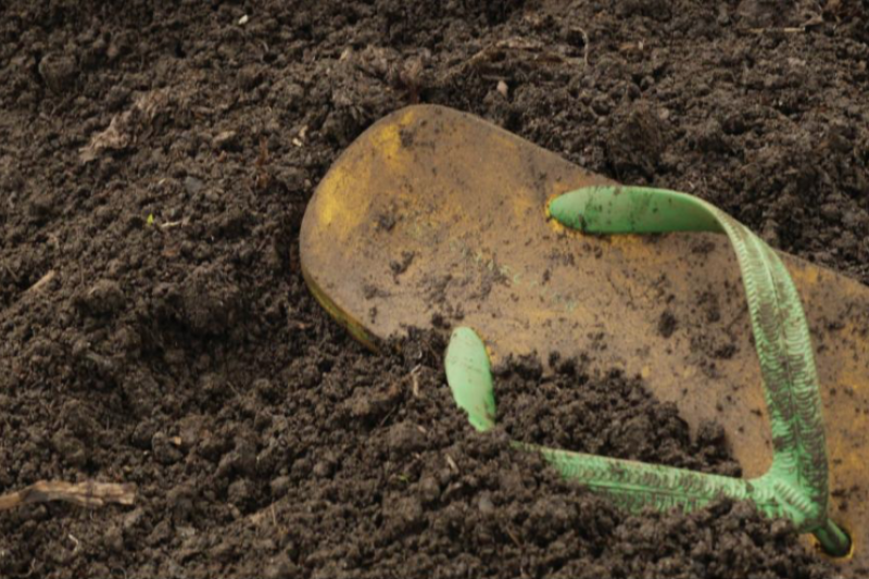 Mass Grave Photo - Flip flop in dirt