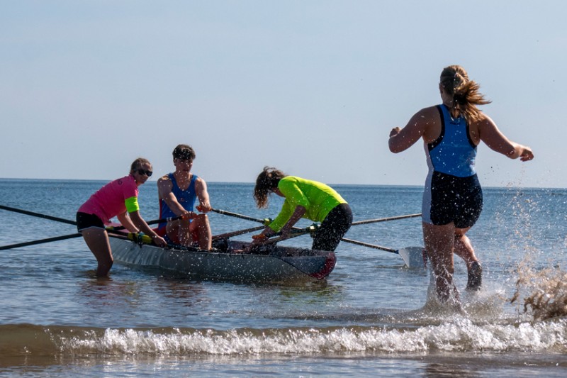 British Rowing contestants on the boat and beach