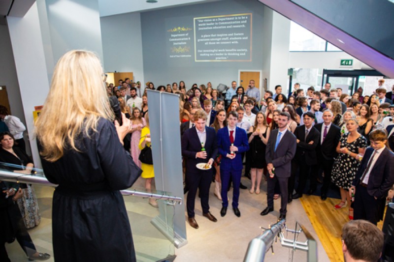 C&J students and staff gathering around a speaker at the opening of the event