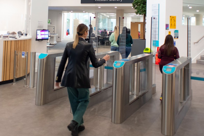 Student using student ID card to enter Bournemouth Gateway Building