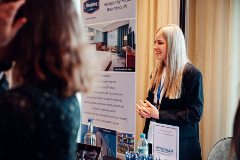 A local business exhibitor talks to delegates at the exhibition