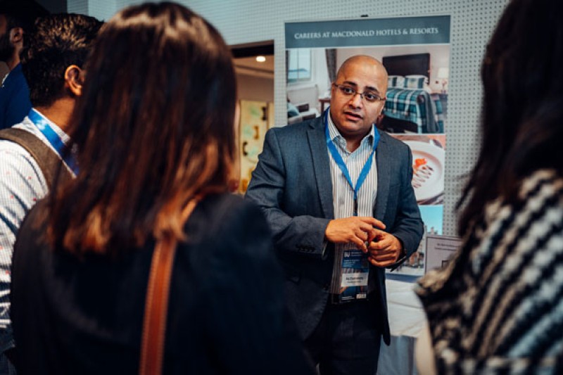 A local business exhibitor talks to delegates at the exhibition