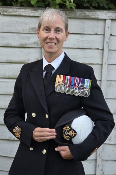 Carolyn wearing her Navy Uniform and displaying multiple medals