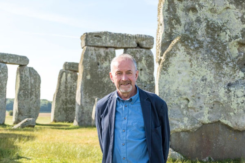 Professor Timothy Darvill standing in front of Stonehenge