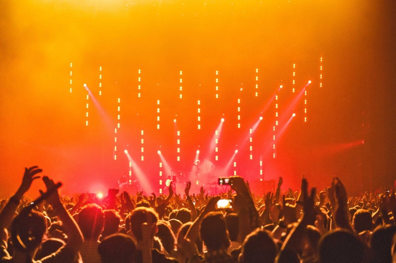A crowd at a concert A crowd at a concert holding up their hands and taking photos
