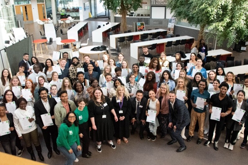 Group photo of award winners holding their certificates.